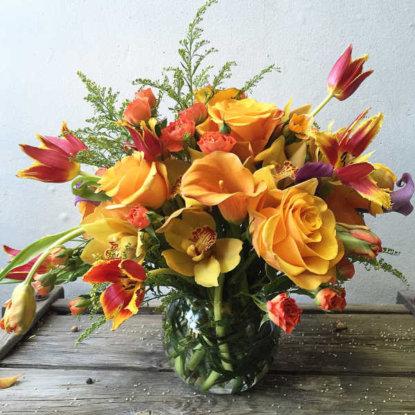 Bouquet of orange and yellow flowers in a glass vase