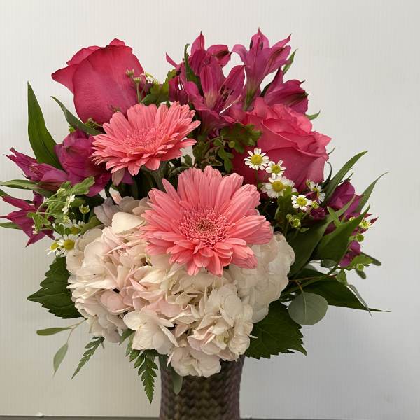 Pink and white mixed bouquet in a textured glass vase