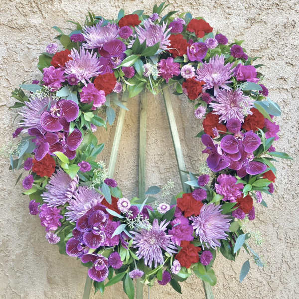 Heart-shaped floral wreath with purple, red, and pink flowers