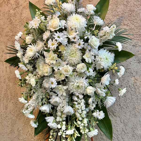 Large white floral standing spray on an easel