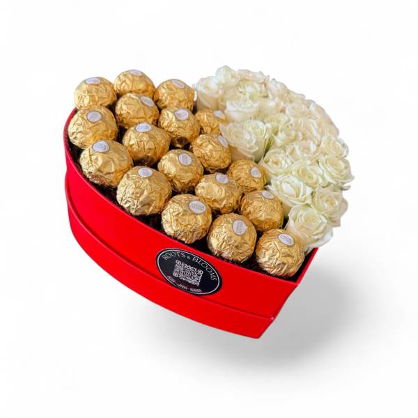 Heart-shaped red box with white roses and gold-wrapped chocolates