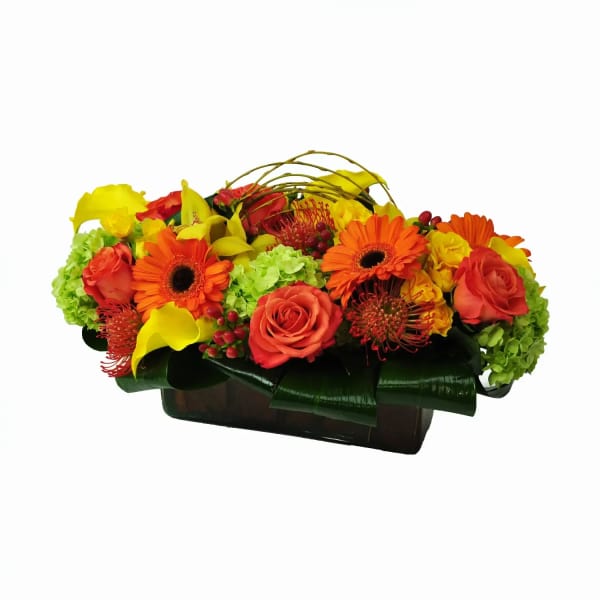 Bright mixed flower arrangement in a dark rectangular container