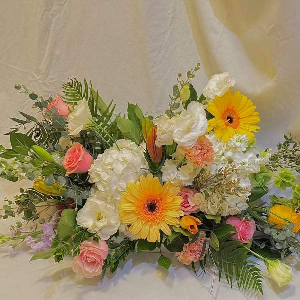 Mixed bouquet with yellow gerbera daisies, pink roses, and white blooms