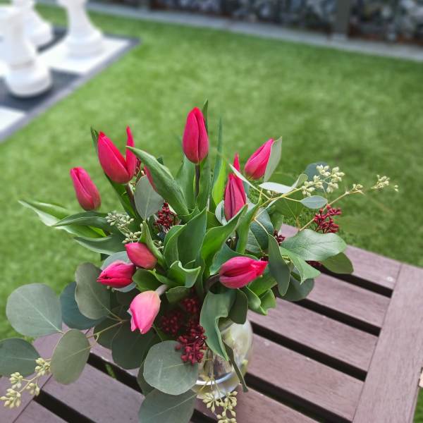 Pink tulip bouquet in a clear glass vase