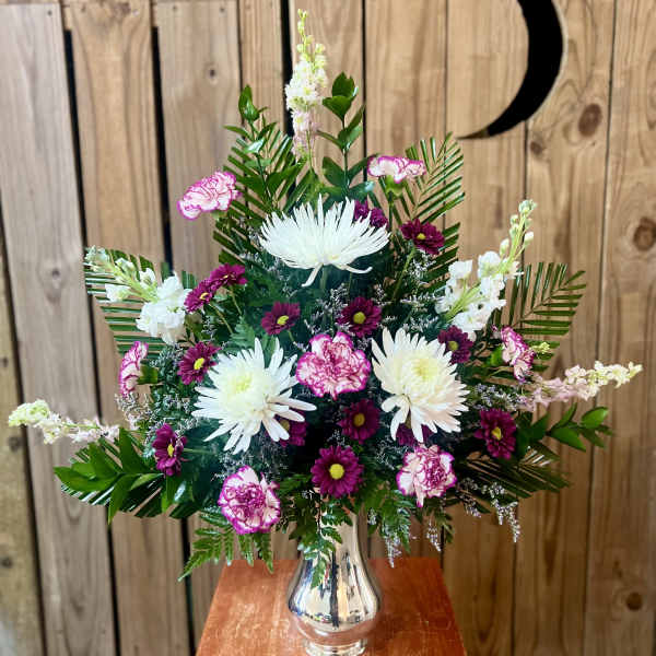 Mixed bouquet of white and pink flowers in a silver vase