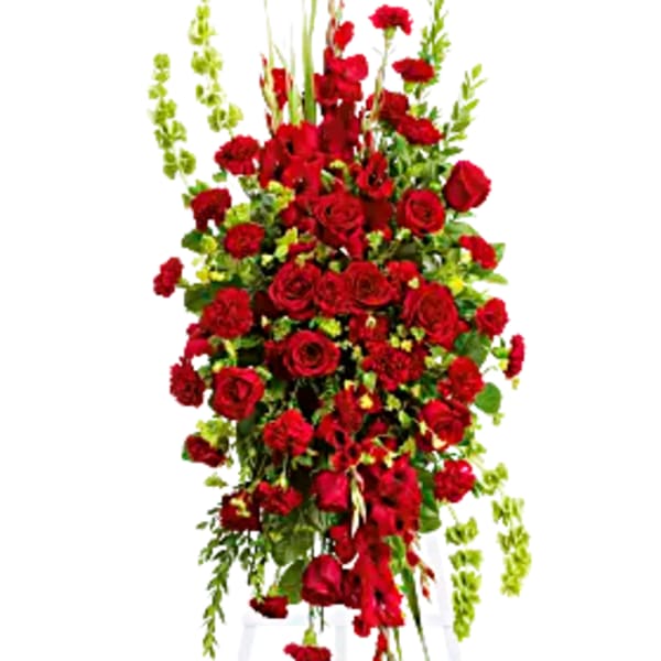 Tall red rose and carnation standing spray on a white easel