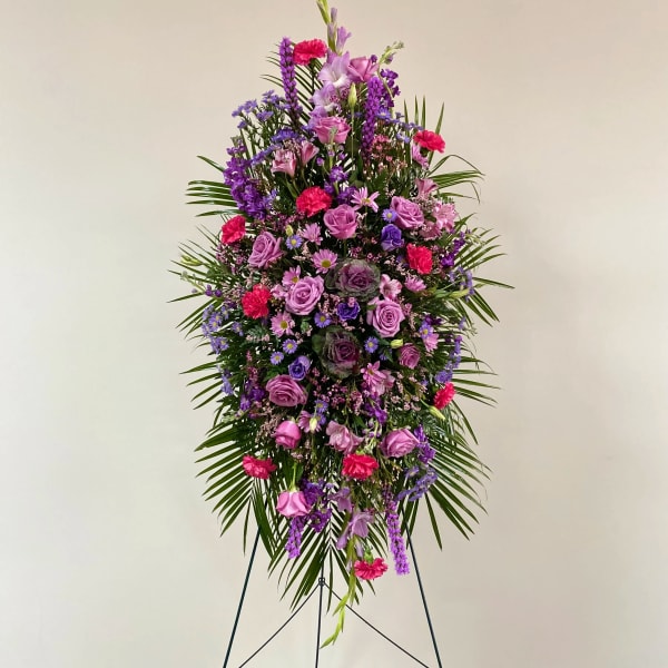 Tall standing floral spray in purple, pink, and magenta tones