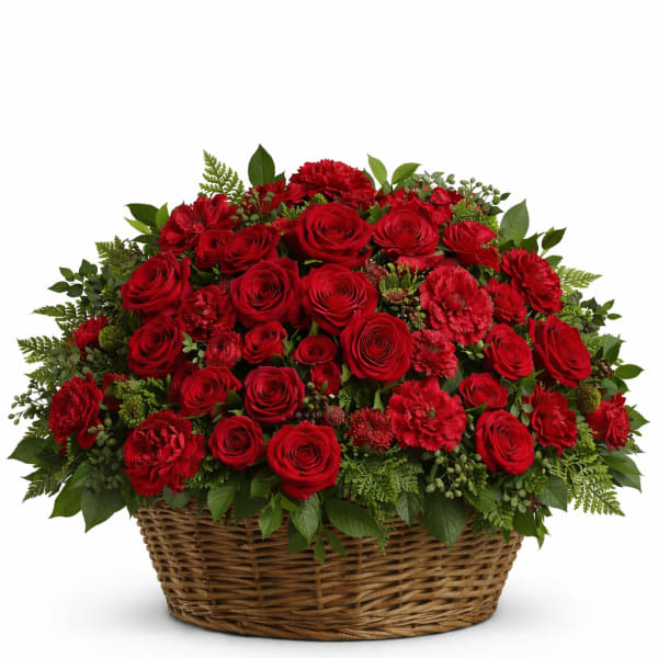 Red roses and carnations arranged in a wicker basket