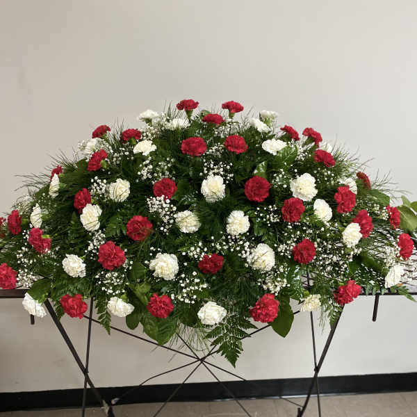 Red and white carnation arrangement on a standing table