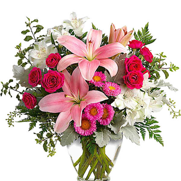 Pink lilies and roses arranged in a clear glass vase