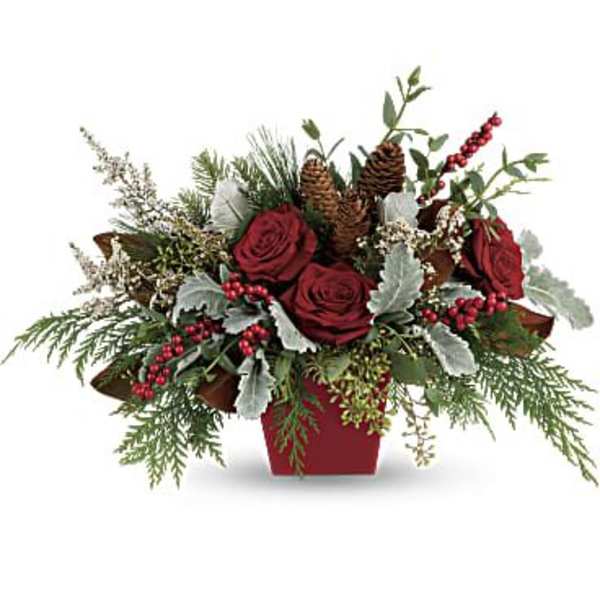 Red roses in a red container with pinecones and berries