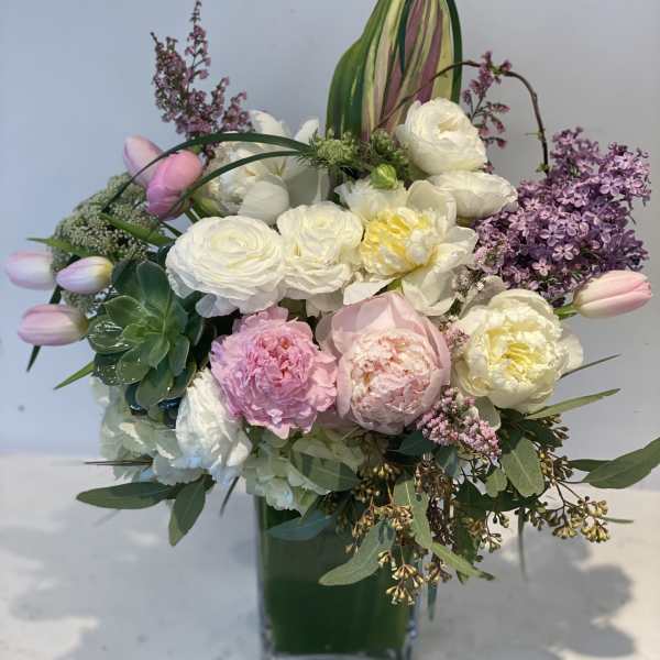 Pink and white mixed bouquet in a tall glass vase