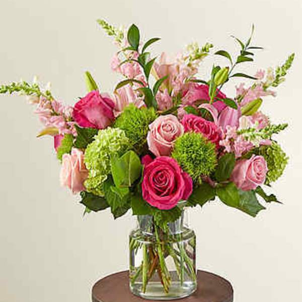 Pink and green mixed bouquet in a clear glass vase