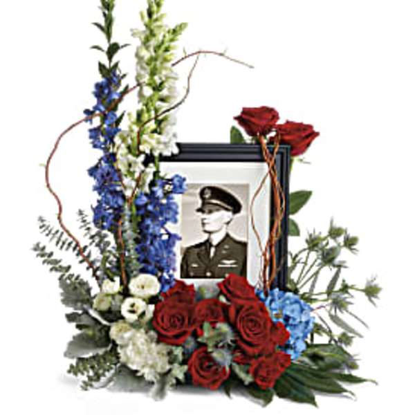 Memorial floral frame with red roses, blue and white flowers, and a portrait