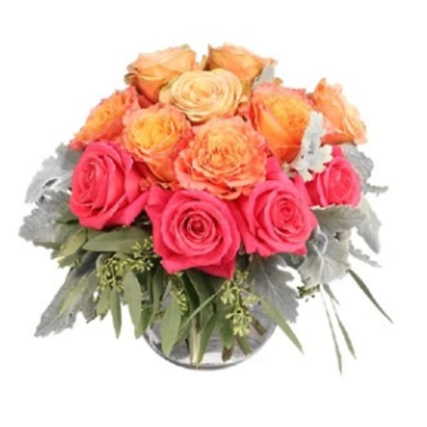 Bouquet of pink and peach roses in a glass vase