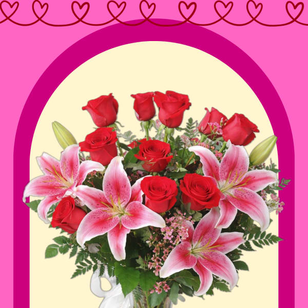 Bouquet of red roses and pink lilies in a glass vase