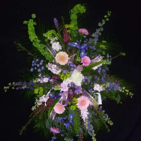 Large standing floral spray with pink, purple, and white flowers