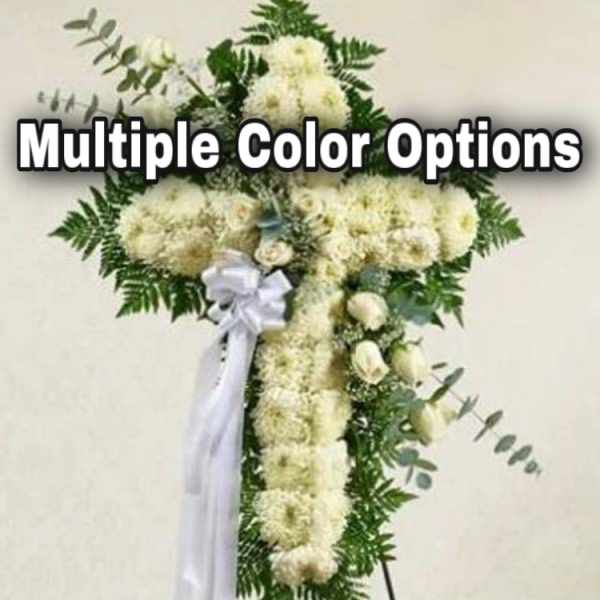 White floral standing spray shaped like a cross with a ribbon