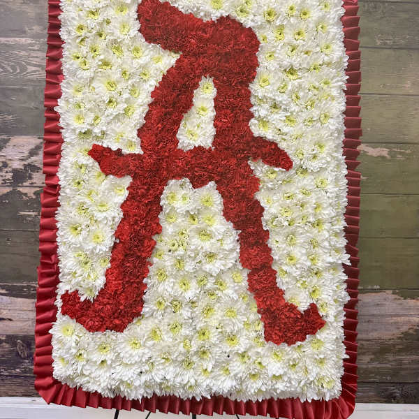 Red and white floral standing tribute with a ribbon border