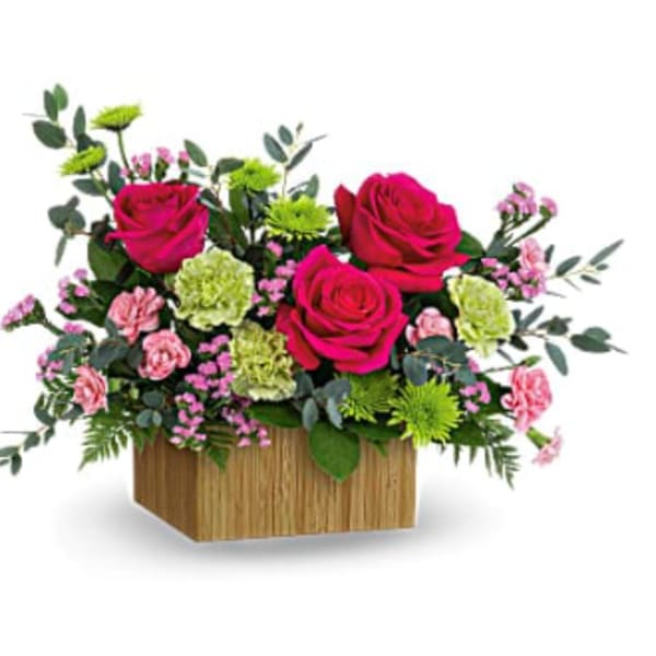 Pink roses and carnations in a wooden box