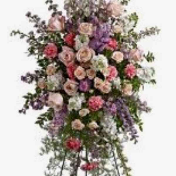 Standing floral spray with pink, purple, and white blooms on an easel