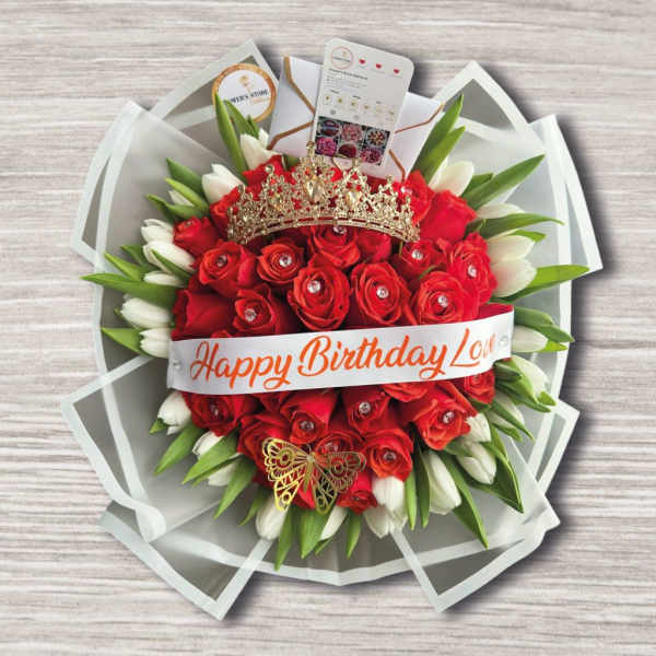 Red rose bouquet with white tulips, a crown, and a birthday ribbon