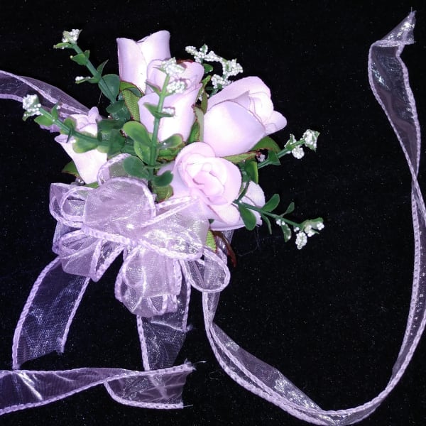 Small bouquet of pale pink roses with a lavender ribbon bow