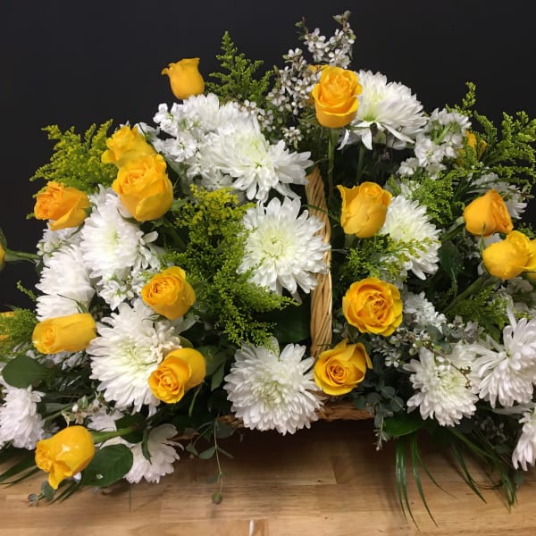 Basket arrangement of yellow roses and white chrysanthemums