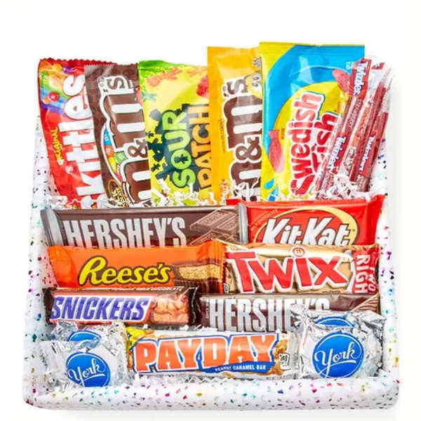 Assorted candy bars and sweets arranged in a gift basket