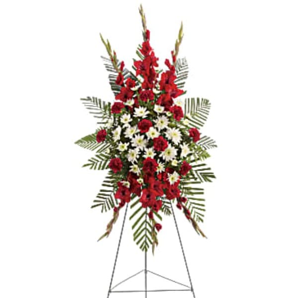 Standing floral spray with red and white flowers on an easel
