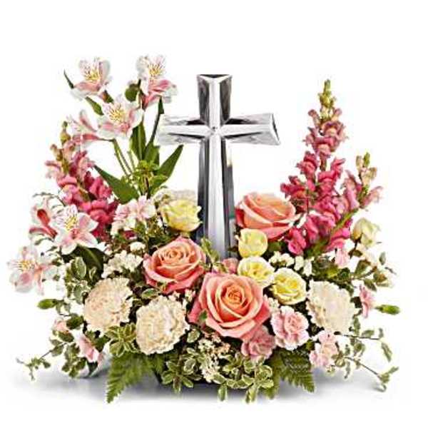 Pink and white floral arrangement with a silver cross centerpiece