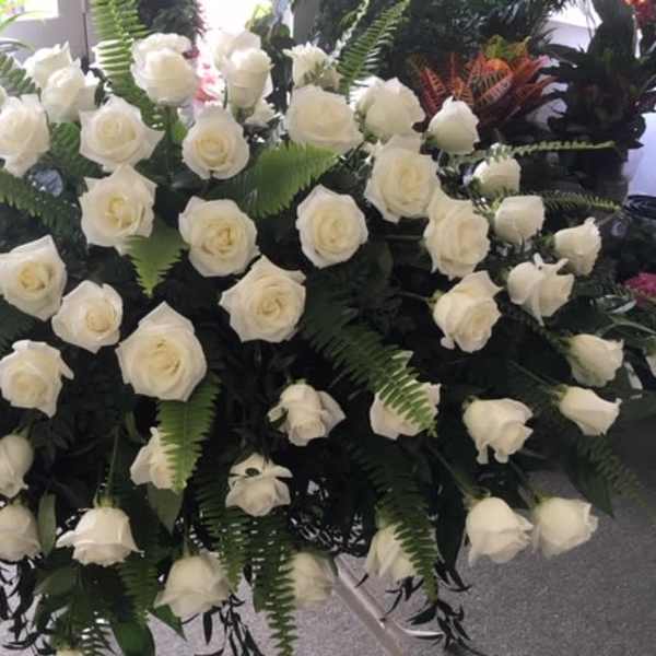 Large arrangement of white roses with fern foliage