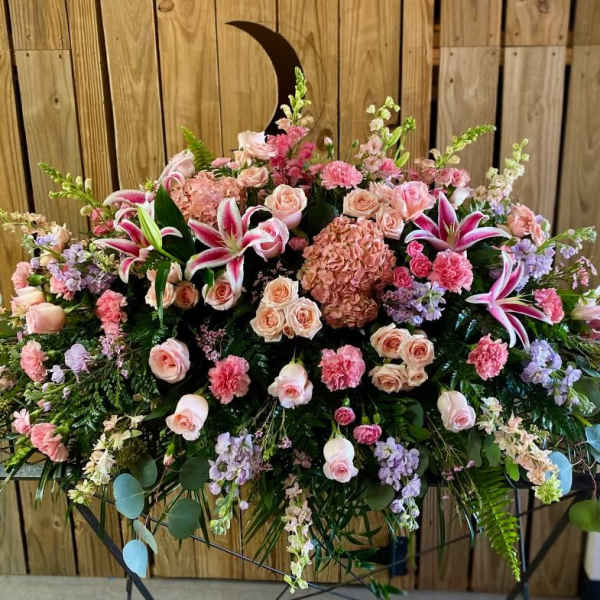 Large pink and peach floral arrangement with lilies and roses
