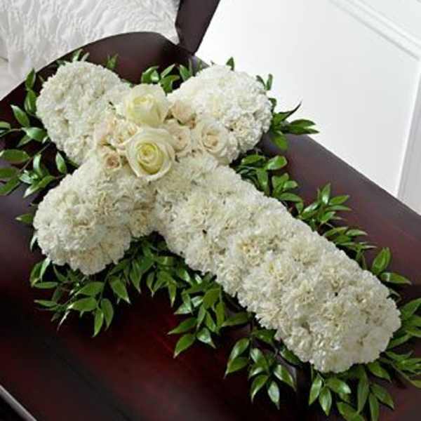 White floral casket spray with roses and greenery
