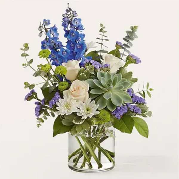 Blue and white mixed bouquet in a clear glass vase