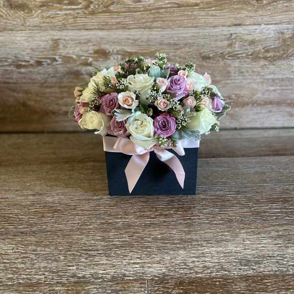 Pastel rose bouquet in a black box with a pink ribbon