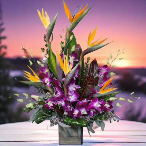 Tropical bouquet with purple orchids and bird of paradise in a square vase