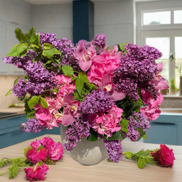 Pink and purple floral arrangement in a gray vase