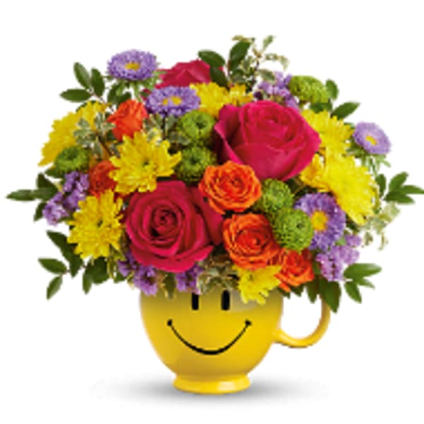 Colorful bouquet in a yellow smiley-face mug