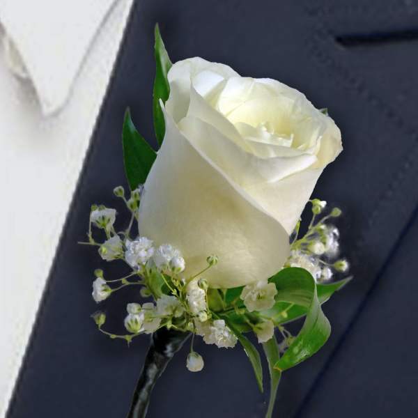 White rose boutonniere with baby's breath and green leaves