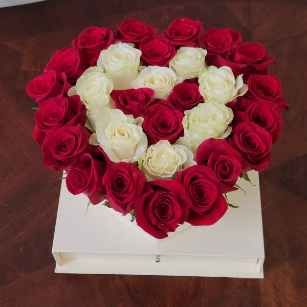 Heart-shaped box of red and white roses