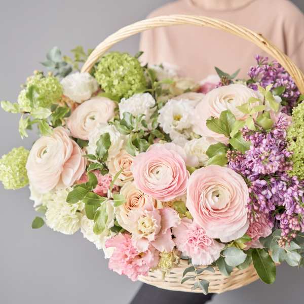 Basket of pastel flowers with pink and white blooms