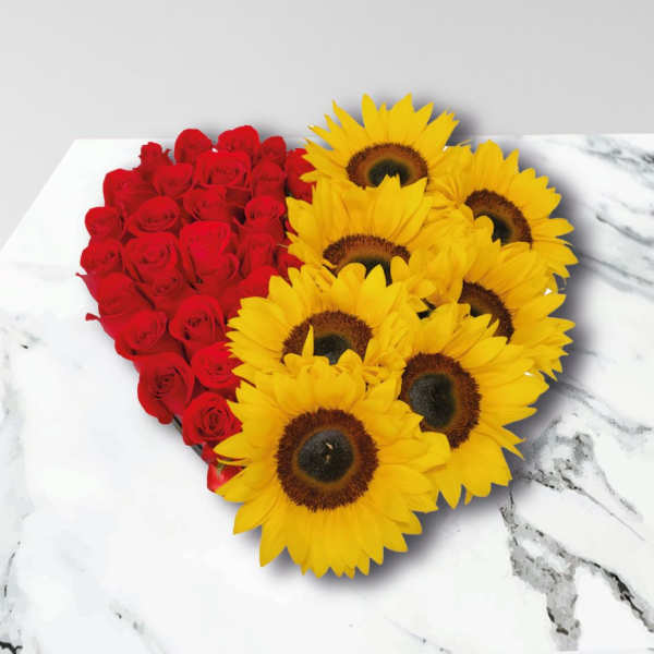 Heart-shaped arrangement of red roses and yellow sunflowers