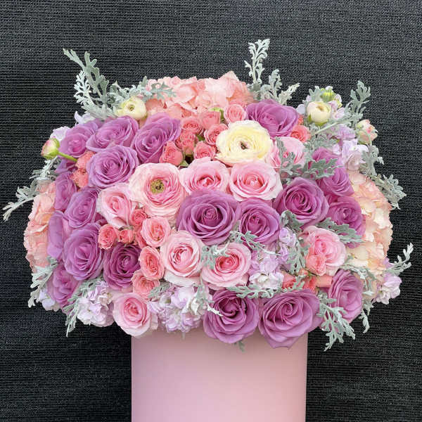Pink and purple rose bouquet in a pastel pink box