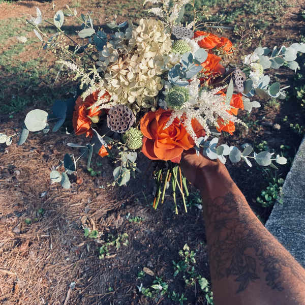 Orange rose bouquet with pale hydrangea and eucalyptus