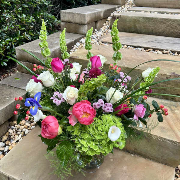Mixed bouquet in a glass vase with pink, white, and green flowers