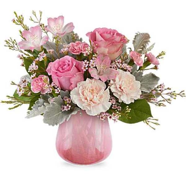Pink and white floral bouquet in a pink glass vase