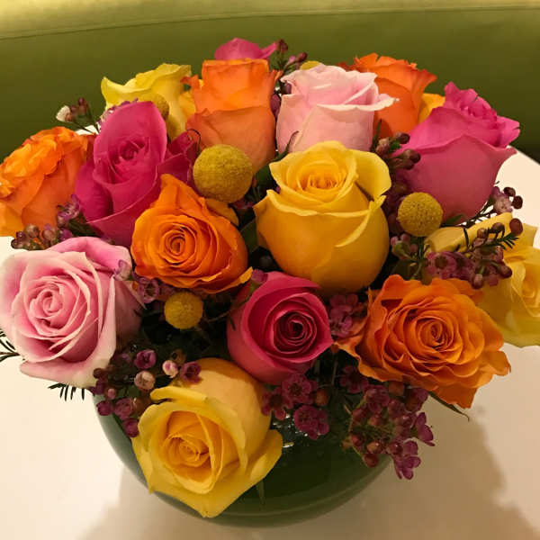 Colorful bouquet of roses in a green vase