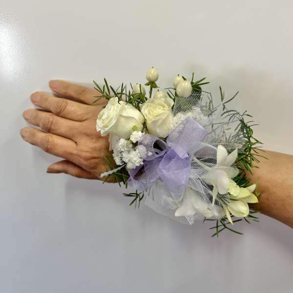 White rose wrist corsage with lavender ribbon and netting