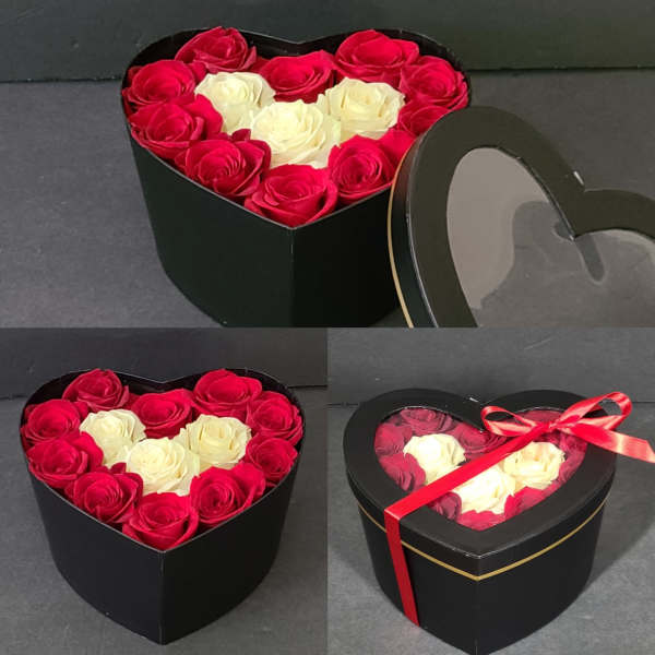 Heart-shaped boxes filled with red and white roses